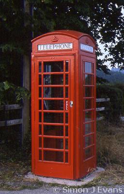 Red telephone box beside a country road near Chirbury